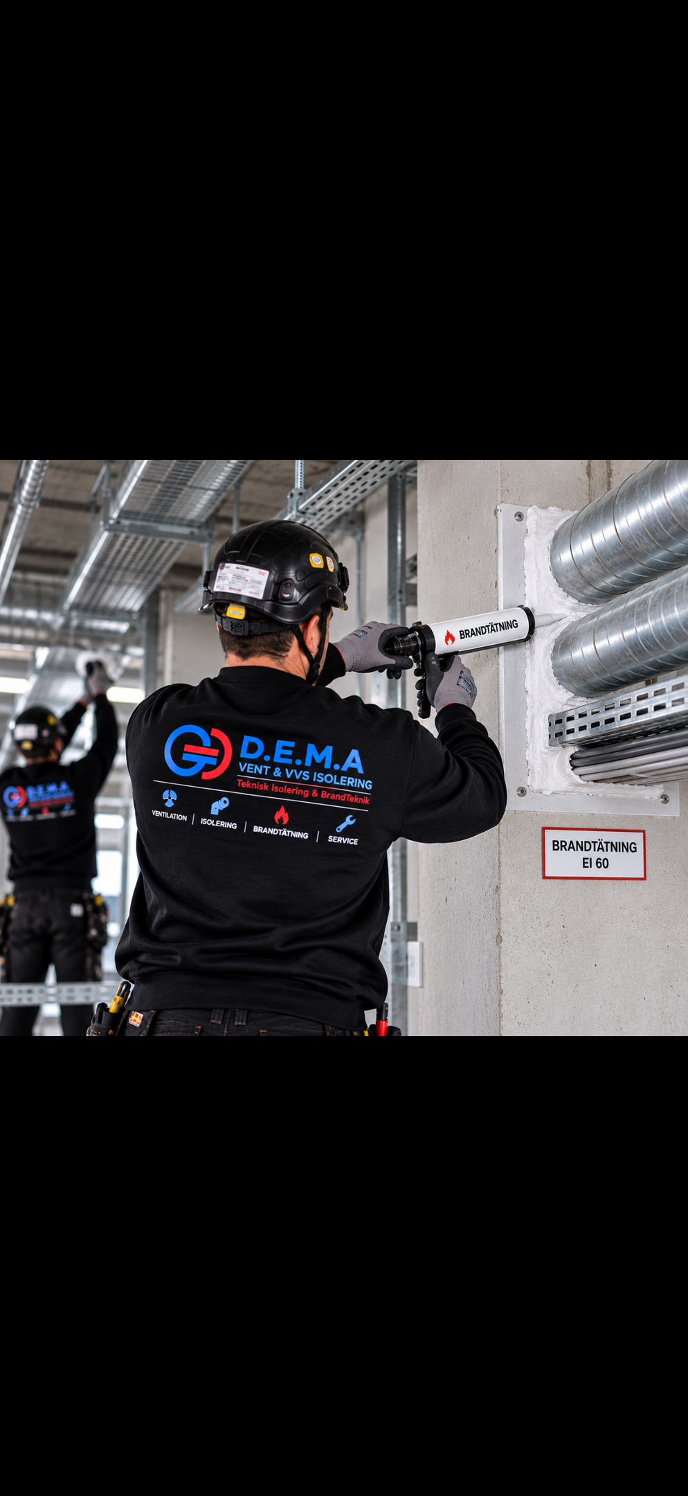 Handy man applies spray fire proof foam to fill space HVC metal pipe in building task occurs indoors during